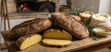 Sliced country bread from Custonaci, a town in northwestern Sicily, in front of flickering flames in a wood-fired oven